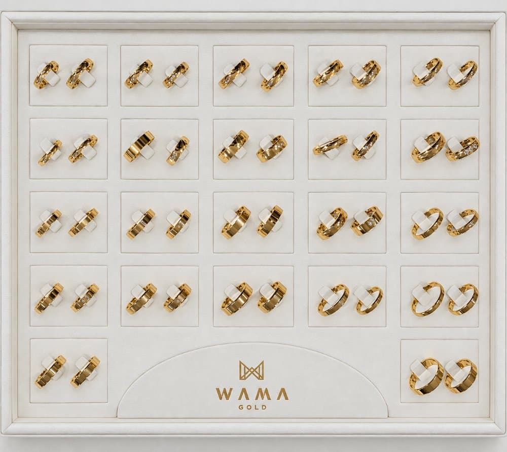 Yellow gold wedding bands in a WAMA GOLD display tray